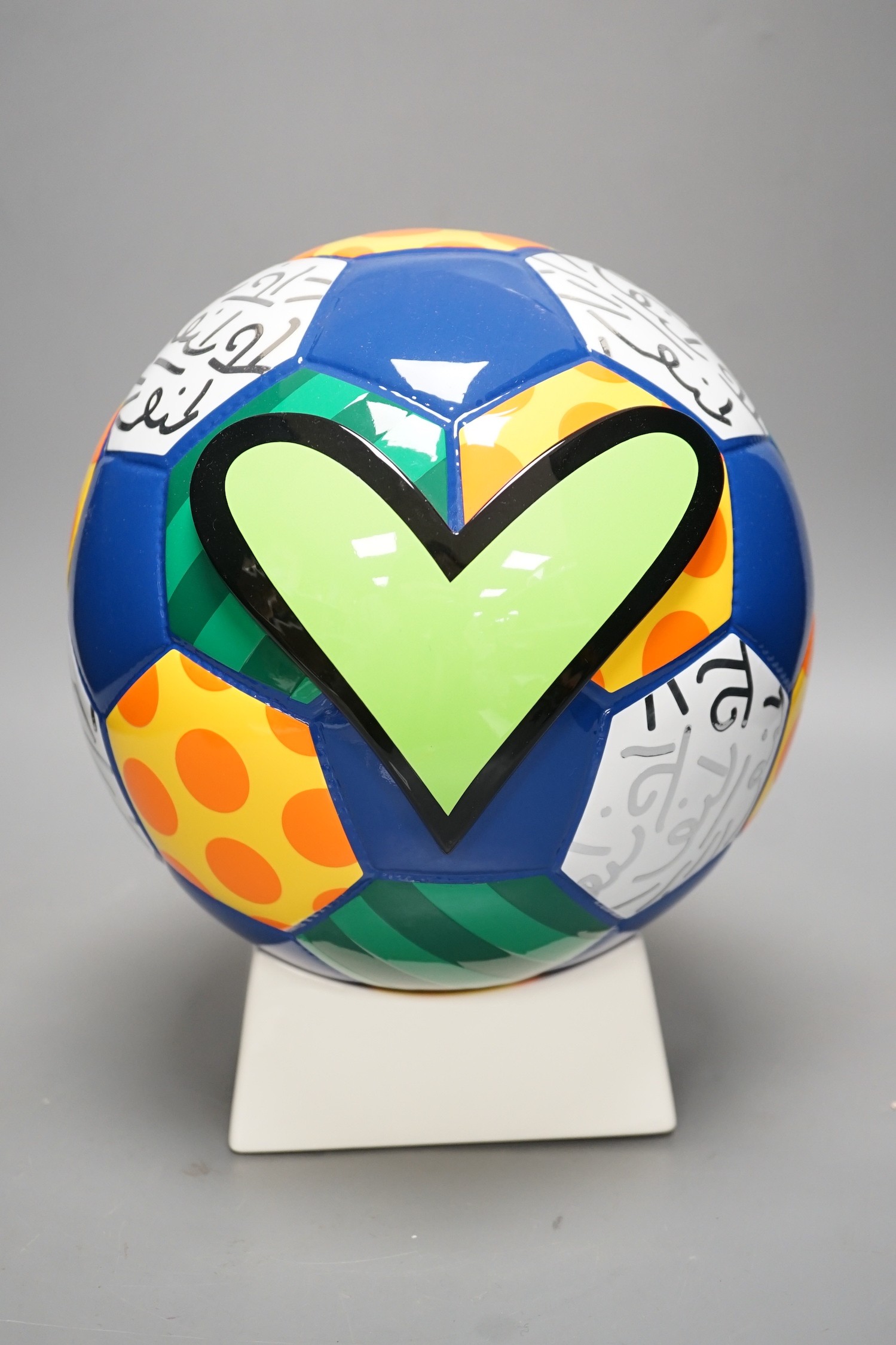 Romero Britto (Brazilian, 1963-), a ceramic football, 26cm